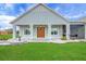 Inviting front porch with stone accents, a double door, and decorative light fixtures at 1679 E County Road 462, Wildwood, FL 34785