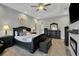 Tranquil main bedroom suite with elegant dark furniture, soft lighting, and a spacious layout for relaxation at 1679 E County Road 462, Wildwood, FL 34785