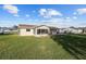 Expansive backyard showing the exterior of the home, including the sunroom and covered patio at 17813 Se 95Th Ct, Summerfield, FL 34491