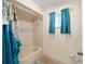 Bathroom featuring a bathtub and shower with teal accents at 17813 Se 95Th Ct, Summerfield, FL 34491