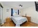 Bedroom with wood-look floors, blue accents and a ceiling fan at 17813 Se 95Th Ct, Summerfield, FL 34491