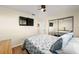 Bedroom featuring wood-look floors, TV and mirror closet doors at 17813 Se 95Th Ct, Summerfield, FL 34491