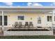 Welcoming front porch features seating, a well-kept flowerbed, and an ADT security system at 17813 Se 95Th Ct, Summerfield, FL 34491