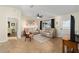 A well-lit living room features tile flooring, a ceiling fan, and comfortable seating at 17813 Se 95Th Ct, Summerfield, FL 34491