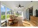 Bright sunroom featuring laminate flooring, ceiling fan and large windows providing an abundance of natural light at 17813 Se 95Th Ct, Summerfield, FL 34491