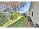 Well-manicured backyard showcasing lush greenery and home's exterior at 17979 Se 89Th Rothway Ct, The Villages, FL 32162