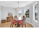 Cozy dining area featuring a round table with wicker chairs and natural light at 17979 Se 89Th Rothway Ct, The Villages, FL 32162