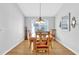 Formal dining room with wooden table and chairs, chandelier, and natural light at 17979 Se 89Th Rothway Ct, The Villages, FL 32162