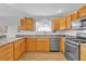 Well-lit kitchen featuring stainless steel appliances, ample cabinet space, and light countertops at 17979 Se 89Th Rothway Ct, The Villages, FL 32162