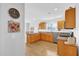 Well-lit kitchen featuring oak cabinets, granite countertops, and stainless steel appliances at 17979 Se 89Th Rothway Ct, The Villages, FL 32162