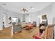 Bright living room with hardwood floors, ceiling fan, and comfortable seating perfect for entertaining at 17979 Se 89Th Rothway Ct, The Villages, FL 32162