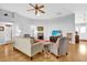 Bright living room with hardwood floors, ceiling fan, and comfortable seating for relaxing at 17979 Se 89Th Rothway Ct, The Villages, FL 32162