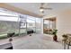 Screened porch with a ceiling fan, sliding glass doors, and potted plants at 17979 Se 89Th Rothway Ct, The Villages, FL 32162