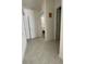 Neutral hallway with tile floors leading to bedrooms and bathrooms at 1799 Post Oak Dr, Davenport, FL 33837