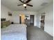 Spacious main bedroom with a ceiling fan, carpet, and access to a bathroom and closet at 1799 Post Oak Dr, Davenport, FL 33837