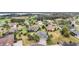 Aerial view of neighborhood featuring manicured lawns, a golf course, and a lake at 2059 Landings Ln, The Villages, FL 32162