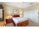 Well-lit bedroom showcasing neutral walls, carpeted flooring, and white closets, creating a serene atmosphere at 2059 Landings Ln, The Villages, FL 32162