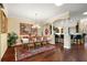 Elegant dining room featuring hardwood floors, a chandelier, and access to the kitchen at 2059 Landings Ln, The Villages, FL 32162