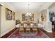 Bright dining room with hardwood floors, a decorative chandelier, and access to the kitchen and living areas at 2059 Landings Ln, The Villages, FL 32162