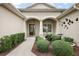 Charming front entrance with meticulously landscaped garden beds and an inviting walkway at 2059 Landings Ln, The Villages, FL 32162