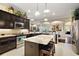 Modern kitchen featuring granite countertops, a center island with seating, and stainless-steel appliances at 2059 Landings Ln, The Villages, FL 32162