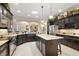 Bright and spacious kitchen with granite countertops, dark cabinetry, and stainless-steel appliances at 2059 Landings Ln, The Villages, FL 32162