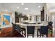 Well-lit kitchen showcasing a large center island with seating and granite countertops at 2059 Landings Ln, The Villages, FL 32162