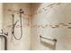 Detailed view of the remodeled shower, featuring tile surround and dual shower heads with a built-in niche at 2059 Landings Ln, The Villages, FL 32162