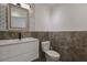 Stylish half-bathroom features a modern vanity, a mirror, and chic tile accents at 210 Palermo Pl, Lady Lake, FL 32159