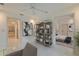 Comfortable seating area complemented by a stylish bookcase, with views into other rooms at 210 Palermo Pl, Lady Lake, FL 32159