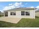 Exterior view of the home showing a patio and well-maintained yard at 2184 Locklin Ln, The Villages, FL 32163