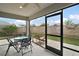 Screened patio featuring modern furniture and a ceiling fan, perfect for outdoor relaxation at 2184 Locklin Ln, The Villages, FL 32163