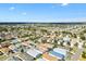 An aerial view of a home with blue awnings located in a well-maintained residential community on a sunny day at 2495 Birch Ave, The Villages, FL 32162