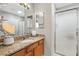 Bathroom with modern fixtures, vanity with granite countertop, and glass shower at 2495 Birch Ave, The Villages, FL 32162