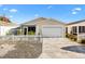 Charming single-story home features a well-manicured lawn, white picket fence, and attached garage at 2495 Birch Ave, The Villages, FL 32162