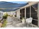 Relaxing covered patio with stylish seating, patterned concrete, and a retractable awning at 2495 Birch Ave, The Villages, FL 32162