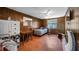 Cozy bedroom featuring wood paneled walls, unique brick pattern floors, and a ceiling fan at 2610 Stephens Rd, Groveland, FL 34736