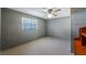 Bedroom with gray walls, a window with blinds, ceiling fan, and wood floors at 2610 Stephens Rd, Groveland, FL 34736