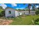 White exterior of home showing the side and back with a brick patio area and green lawn at 2610 Stephens Rd, Groveland, FL 34736