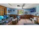 Living room with blue walls, wood trim, and a large window offering a verdant view at 2610 Stephens Rd, Groveland, FL 34736