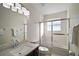 Bright bathroom featuring a shower-tub combo, sleek vanity, and stylish lighting at 26608 E Cove Dr, Tavares, FL 32778