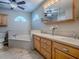 Well-lit bathroom with double vanity, soaking tub, and neutral color palette at 26608 E Cove Dr, Tavares, FL 32778