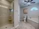 Bathroom featuring glass-enclosed shower and soaking tub with transom windows at 26608 E Cove Dr, Tavares, FL 32778