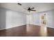 This bedroom is empty with hardwood floors and a view into the bathroom at 26608 E Cove Dr, Tavares, FL 32778