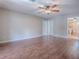 Bedroom featuring hardwood floors, ceiling fan, and neutral paint at 26608 E Cove Dr, Tavares, FL 32778