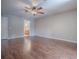 Spacious bedroom featuring hardwood floors, ceiling fan, and neutral paint at 26608 E Cove Dr, Tavares, FL 32778