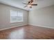 Bedroom with hardwood floors and a large window offering natural light at 26608 E Cove Dr, Tavares, FL 32778