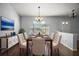 This dining room features a window with a scenic view, a modern chandelier and stylish decor at 26608 E Cove Dr, Tavares, FL 32778