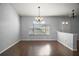 This dining room features a window with a scenic view and a modern chandelier at 26608 E Cove Dr, Tavares, FL 32778