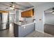 Kitchen island with counter seating, stainless steel appliances, and wood cabinets at 26608 E Cove Dr, Tavares, FL 32778